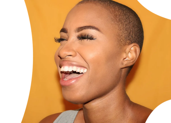 Woman of colour laughing and showing beautiful teeth.