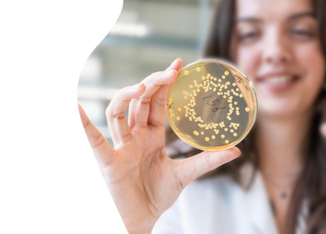 Female Winclove Probiotics lab technician looks at a bacterial sample