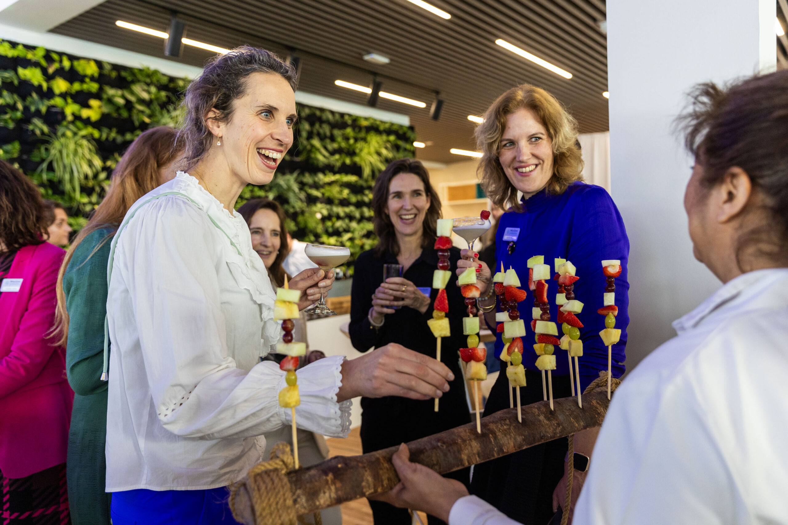 Female employees of Winclove Probiotics sharing a drink and a bite at a company party