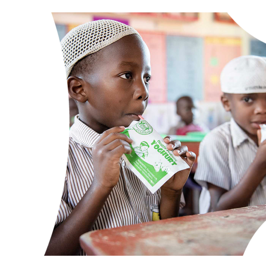 Two small African boys enjoying probiotic yohghurt