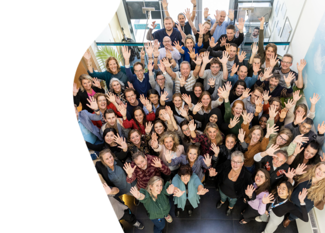 Happy employees of Winclove Probiotics, smiling and waving to prove that this is a Great Place To Work.