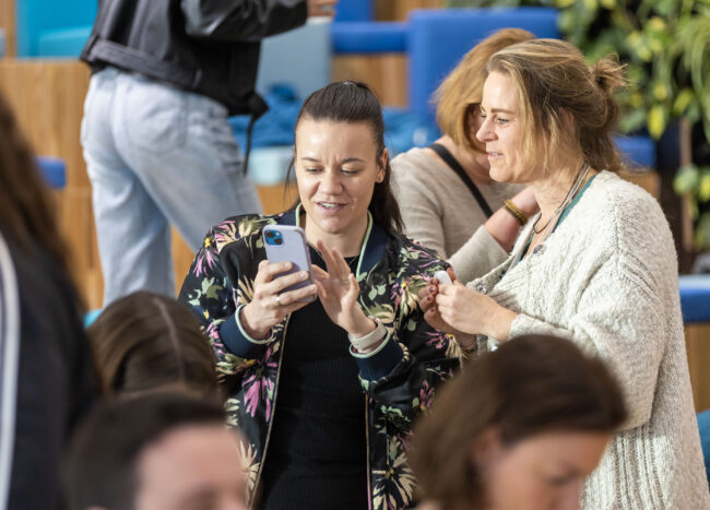 Female employees reading the Winclove Probiotics newsletter